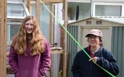 A person and person standing next to each other and smiling  Description automatically generated with low confidence